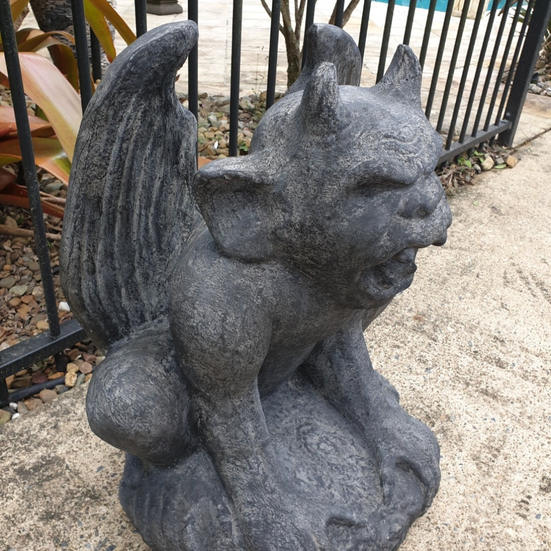 A rustic style gargoyle garden statue made from reinforced concrete and glass fiber, displayed in a natural outdoor setting.