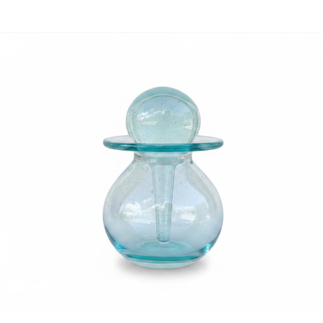Glass oil bottle applicator assembled and closed, front view on white background