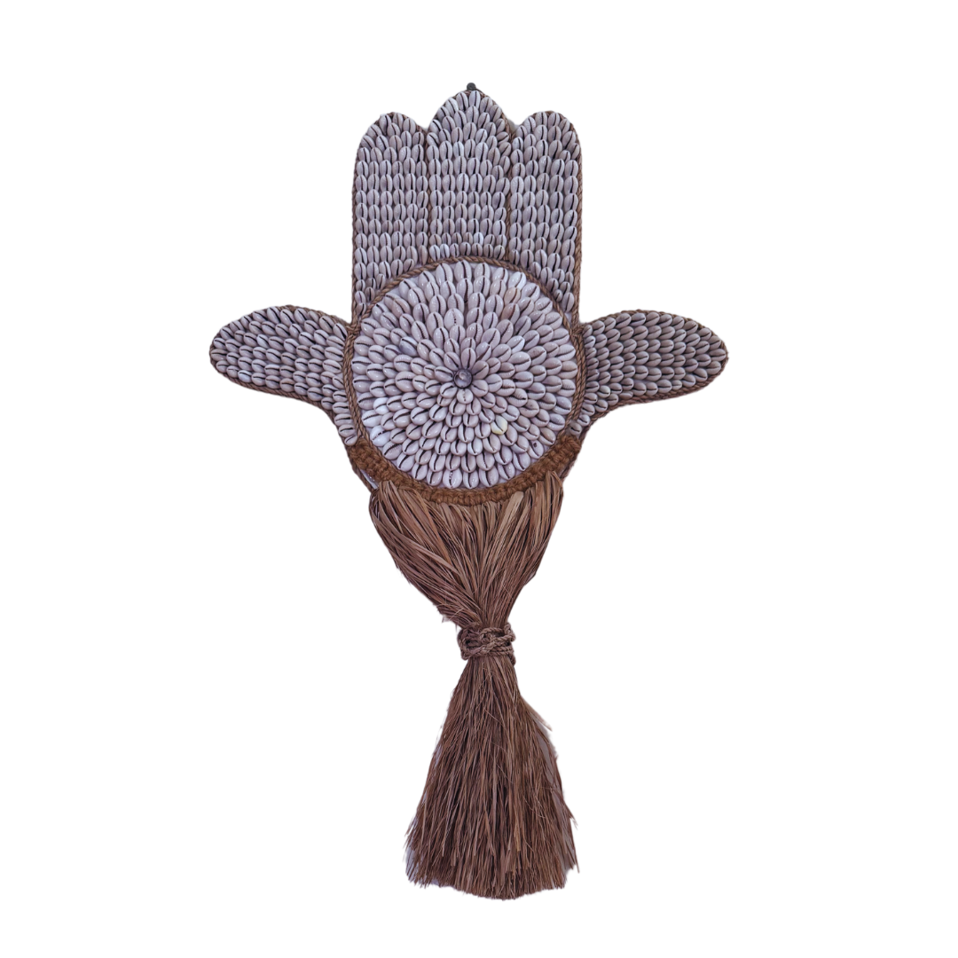 Decorative Hamsa hand with knitted pattern and brown tassel on a white background