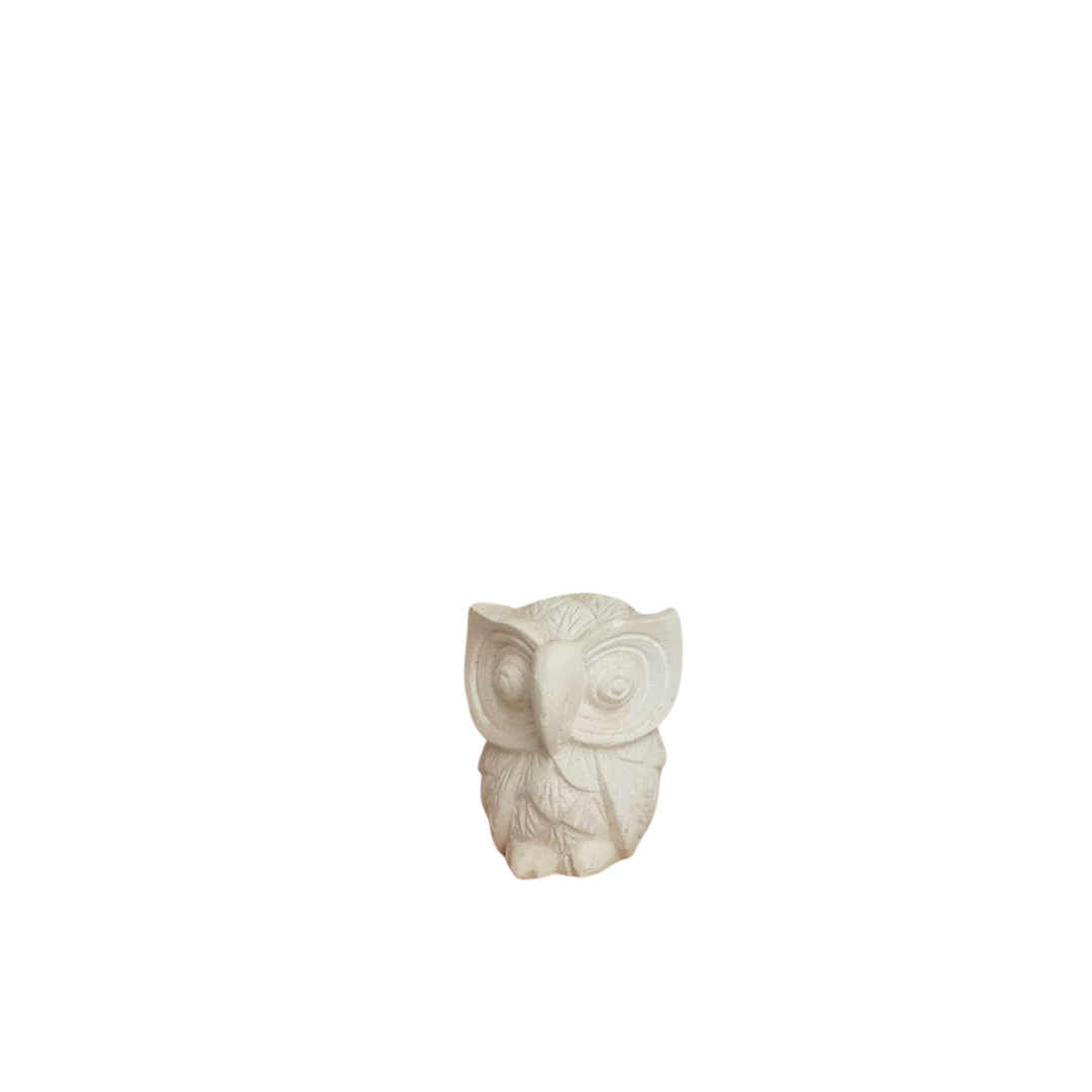 A  limestone carving of owl in  from  smallest, with a plain background.
