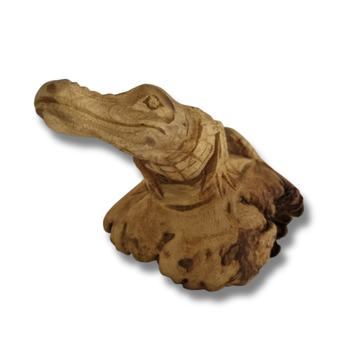 Wooden alligator figurine on a white background