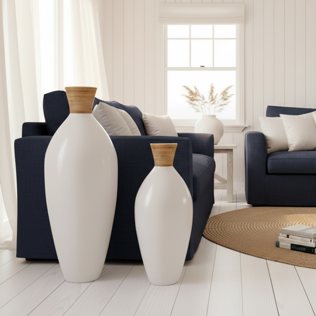 White vases with wooden tops on a light wood floor in a living room setting.