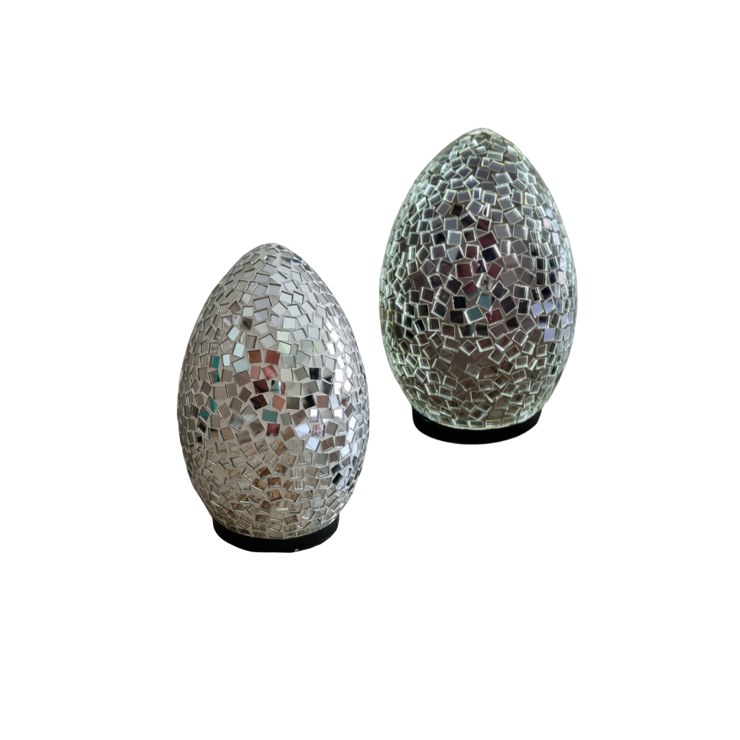 Two unlit glass tile pieces in silver and multicolour geometric pattern, on white background