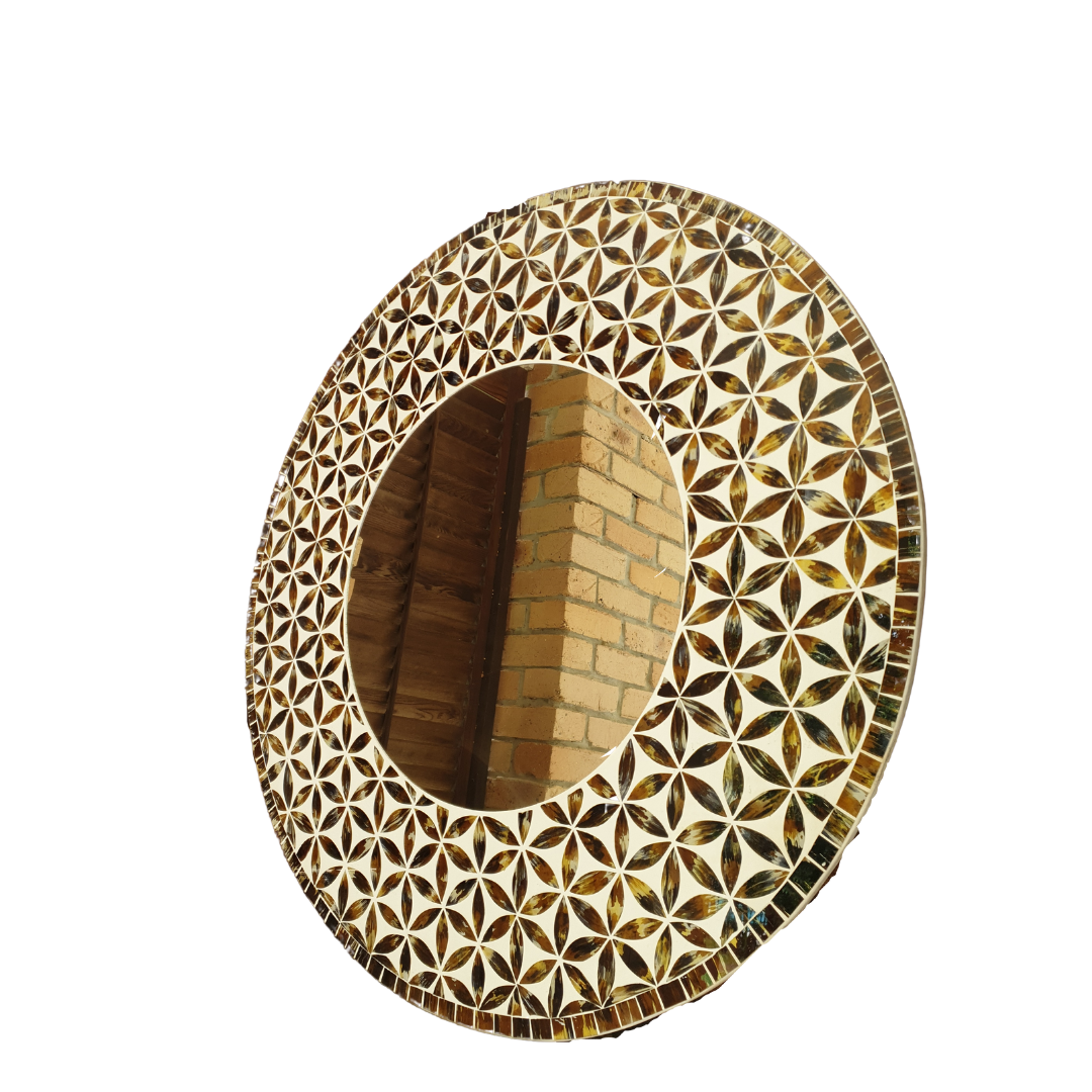 Angle shot with a brick wall reflection Handmade round mosaic mirror with Flower of Life pattern in warm brown and amber tones — front-on product view on white background