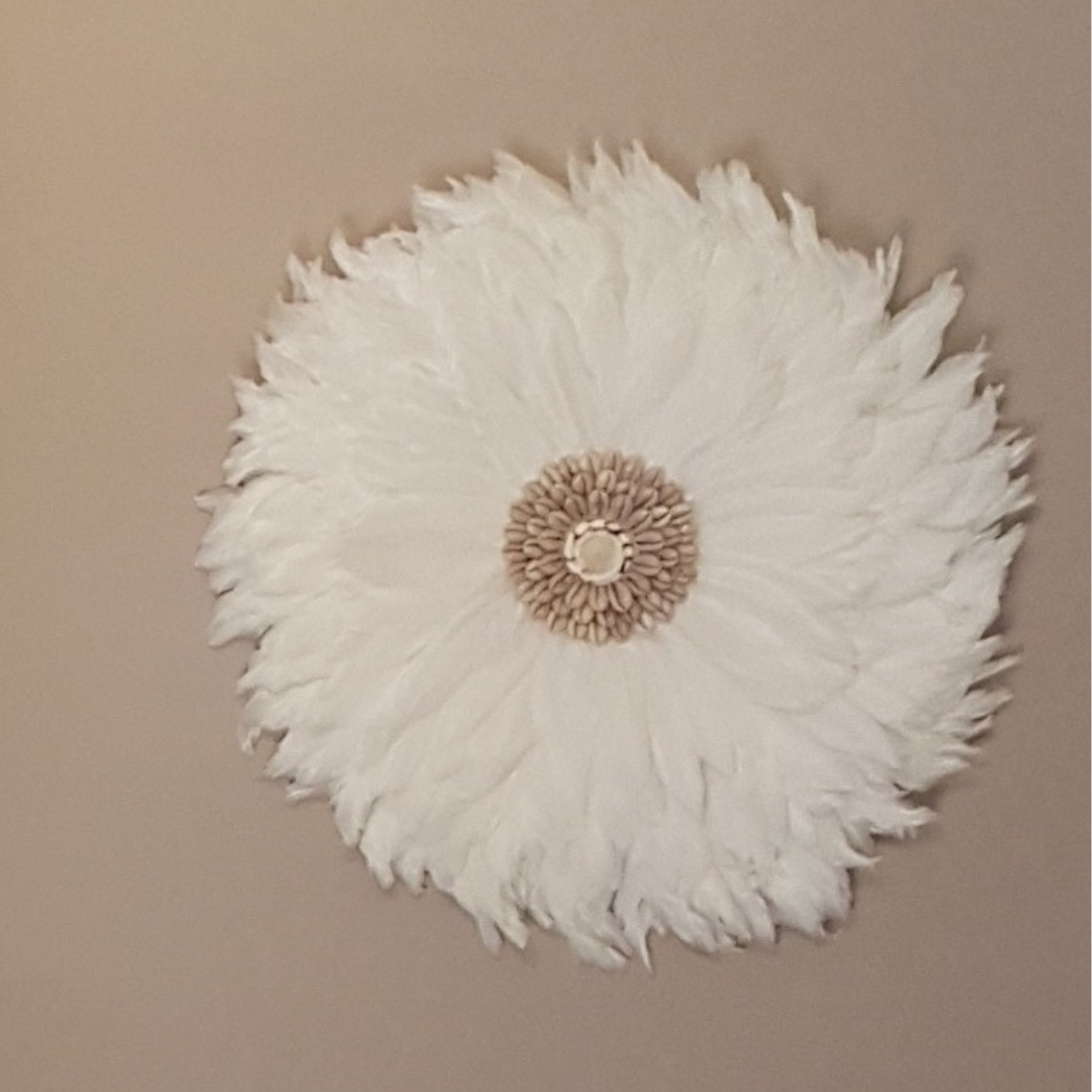 white feathered juju on beige wall 