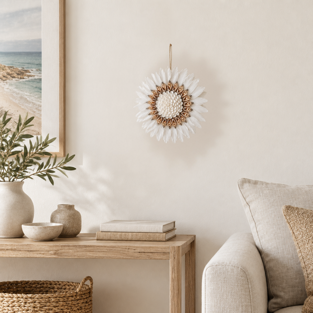 White feather and cowrie shell wall hanging styled in a neutral room