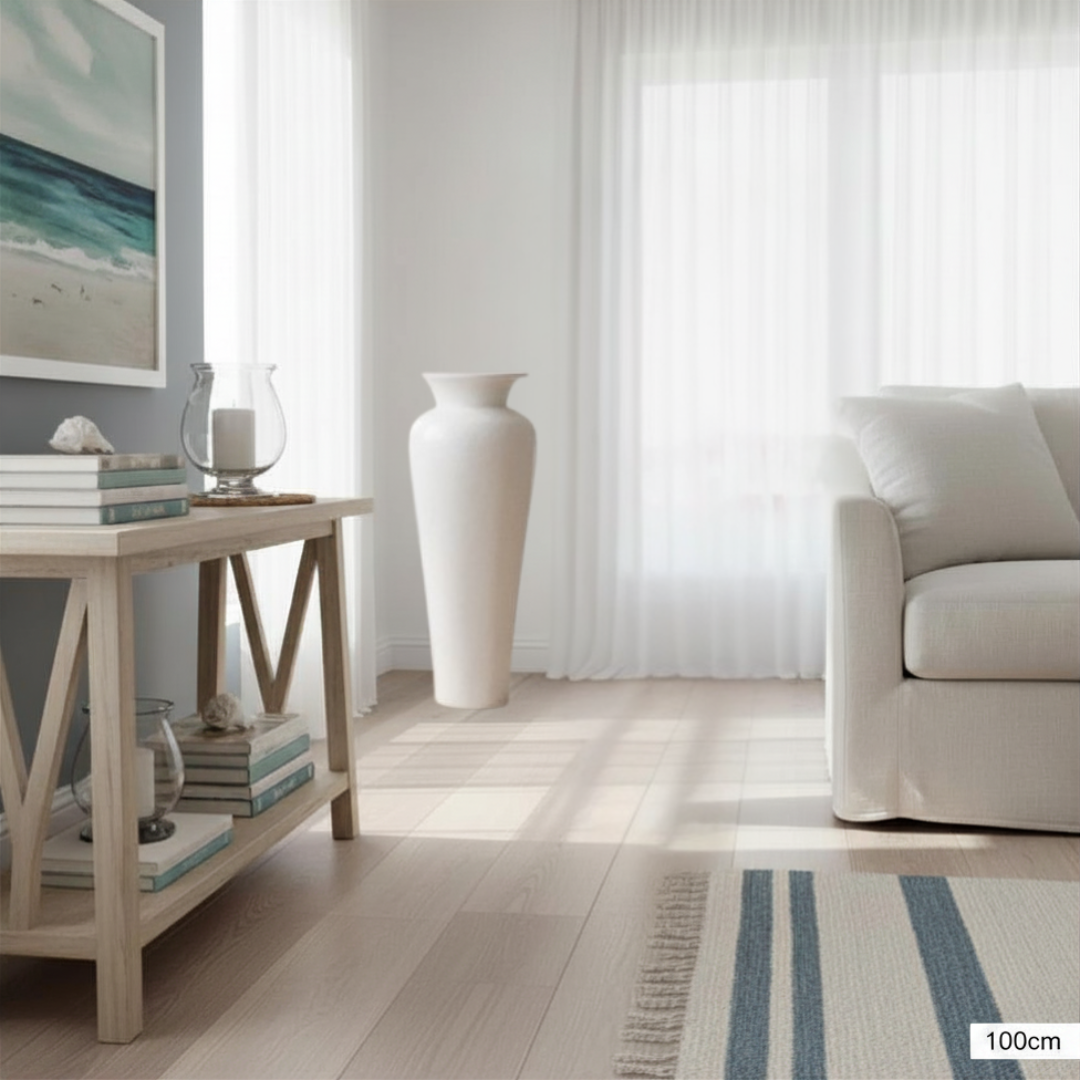 Modern living room with a sofa, side table, and large vase.