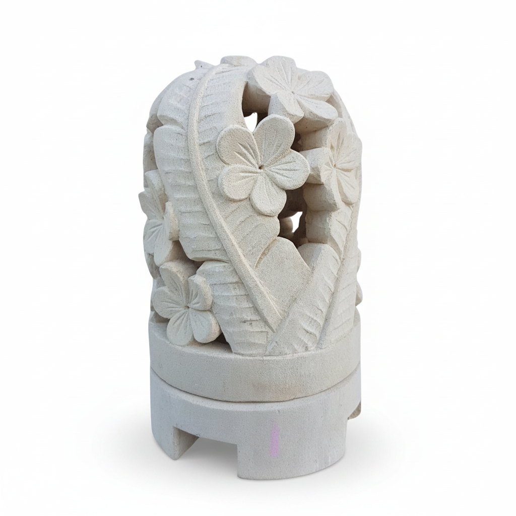 A carved decorative stone sculpture featuring a floral and leaf pattern, mounted on a tiered circular base against a plain white background.
