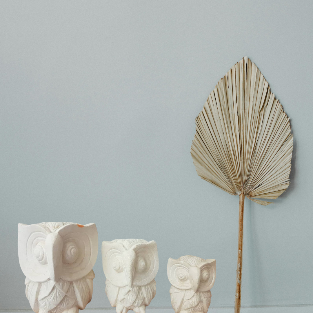 A set of three limestone carvings of owls in decreasing size order, from largest to smallest, living room boho style