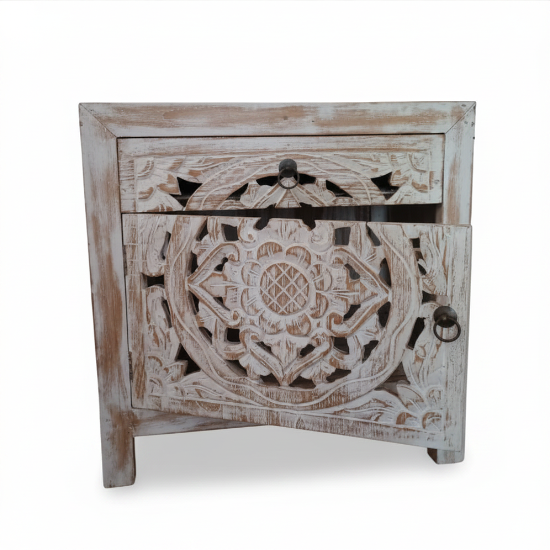 Balinese hand-carved bedside table with open Mandala fretwork cabinet door and ring pull drawer in aged whitewash finish on white background