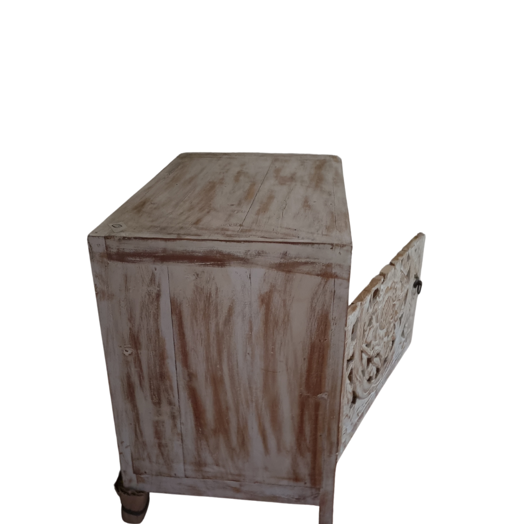 Rear top-down angle of a reclaimed teak bedside cabinet showing natural whitewash wood grain on the top surface and carved Mandala door panel on the side
