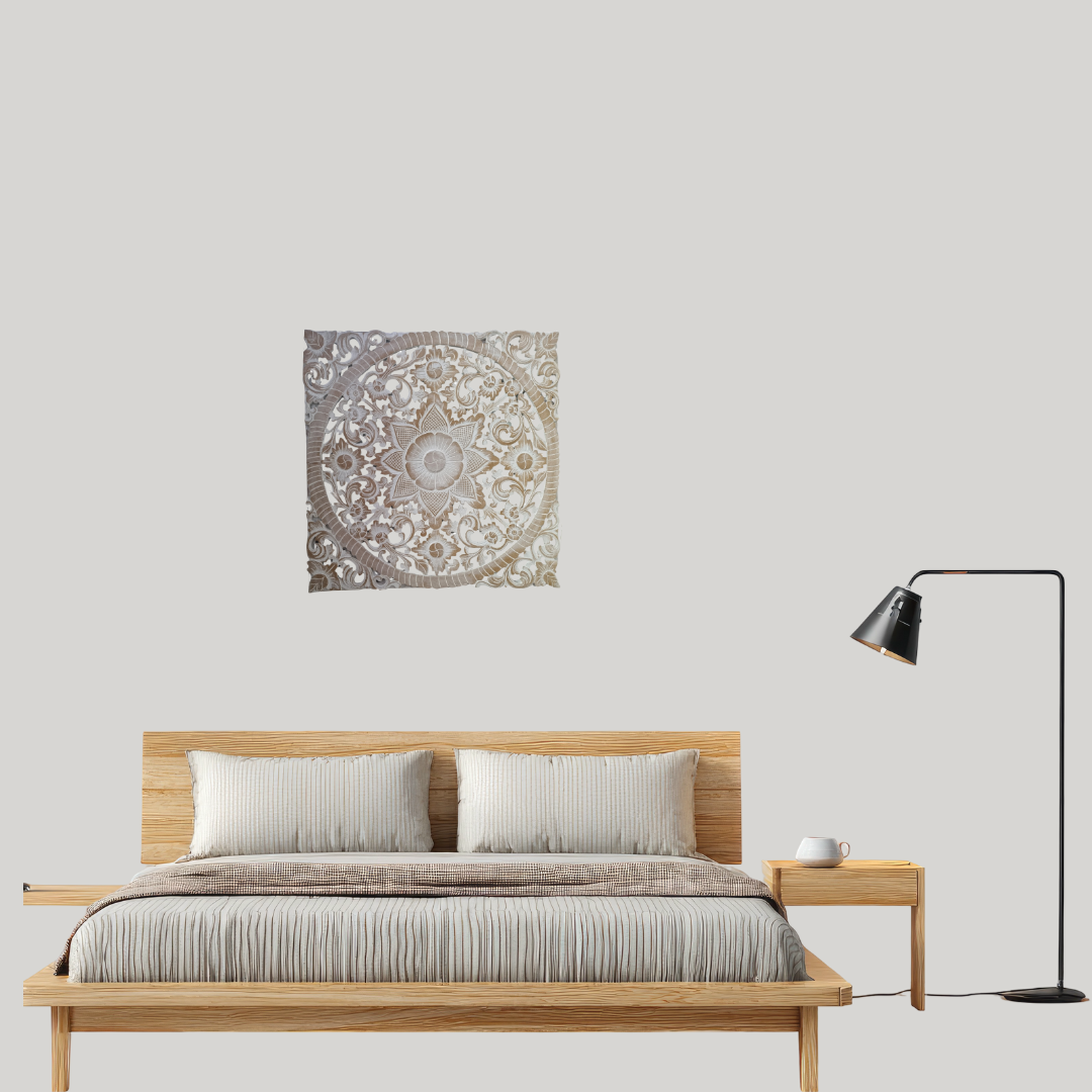 Bedroom with wooden bed, decorative wall art, and lamp on a plain wall.