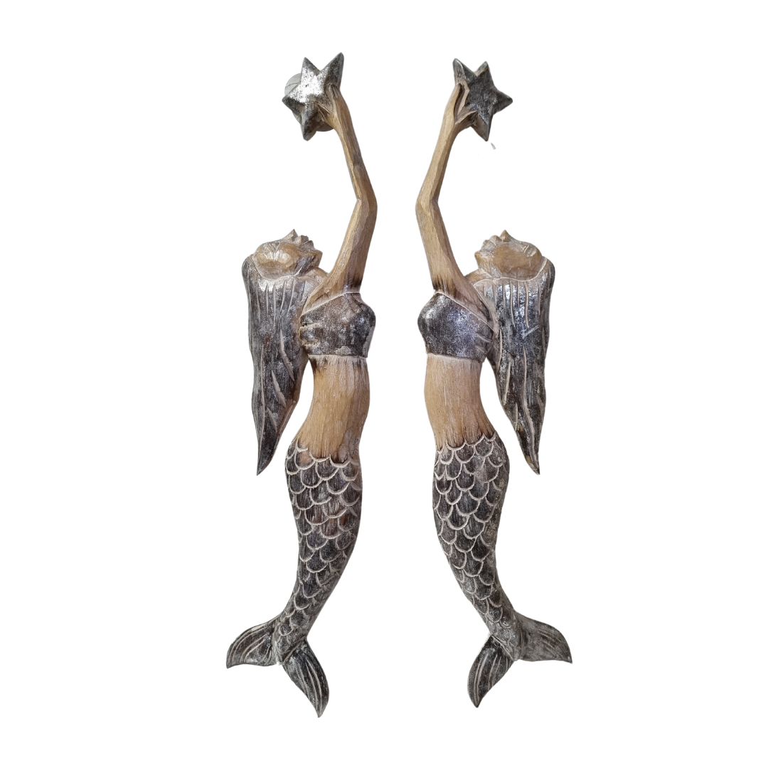 Two mermaid figurines holding starfish on a white background