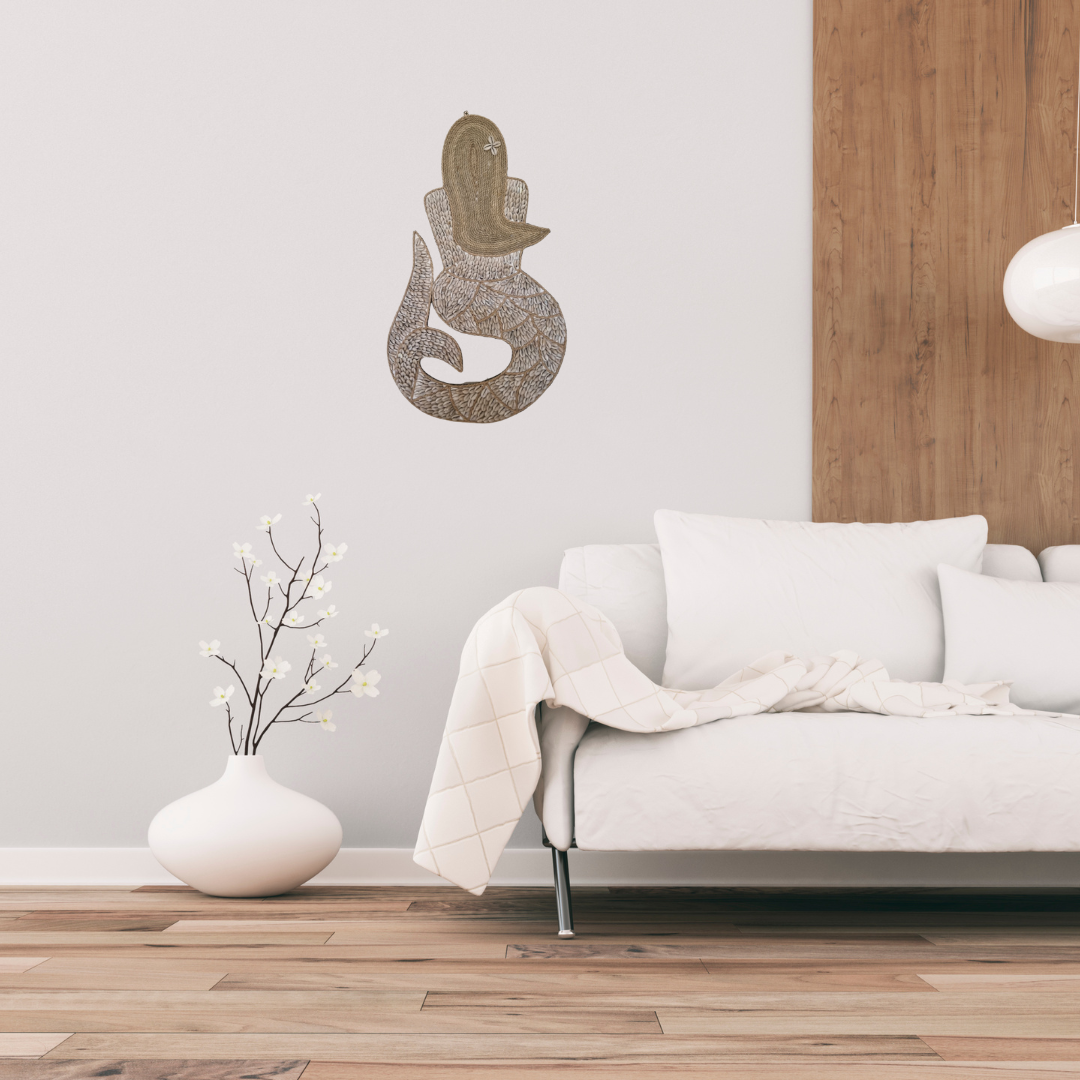 Modern living room with a white sofa, decorative vase, and wall art.