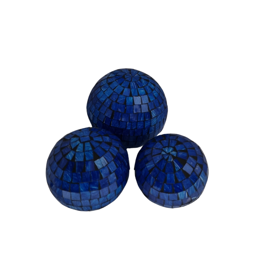 Three blue mosaic glass spheres grouped together on a white background
