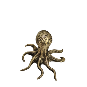 Small solid brass octopus figurine with detailed textured body and eight curling tentacles, photographed on a white background