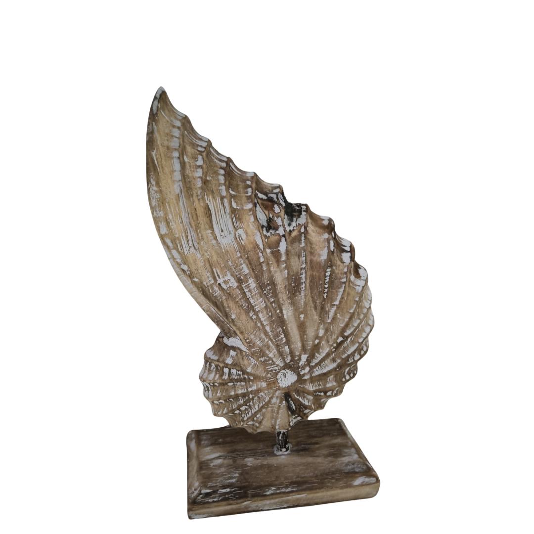 A handcrafted wooden conch shell  decoration on a stand, with a natural brown wash finish on beige back drop 