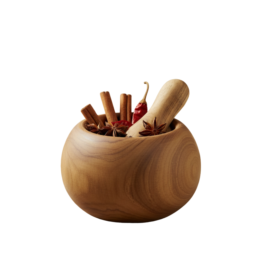 Round teak wood mortar filled with cinnamon sticks, star anise and a dried red chilli, with a wooden pestle resting inside, on a white background