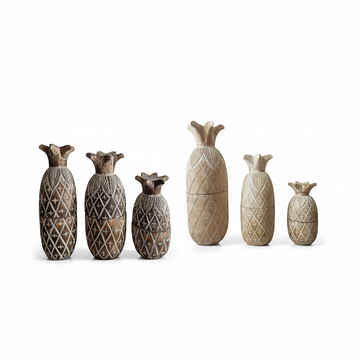 Six carved wooden pineapple canisters arranged in a row against a clean white background