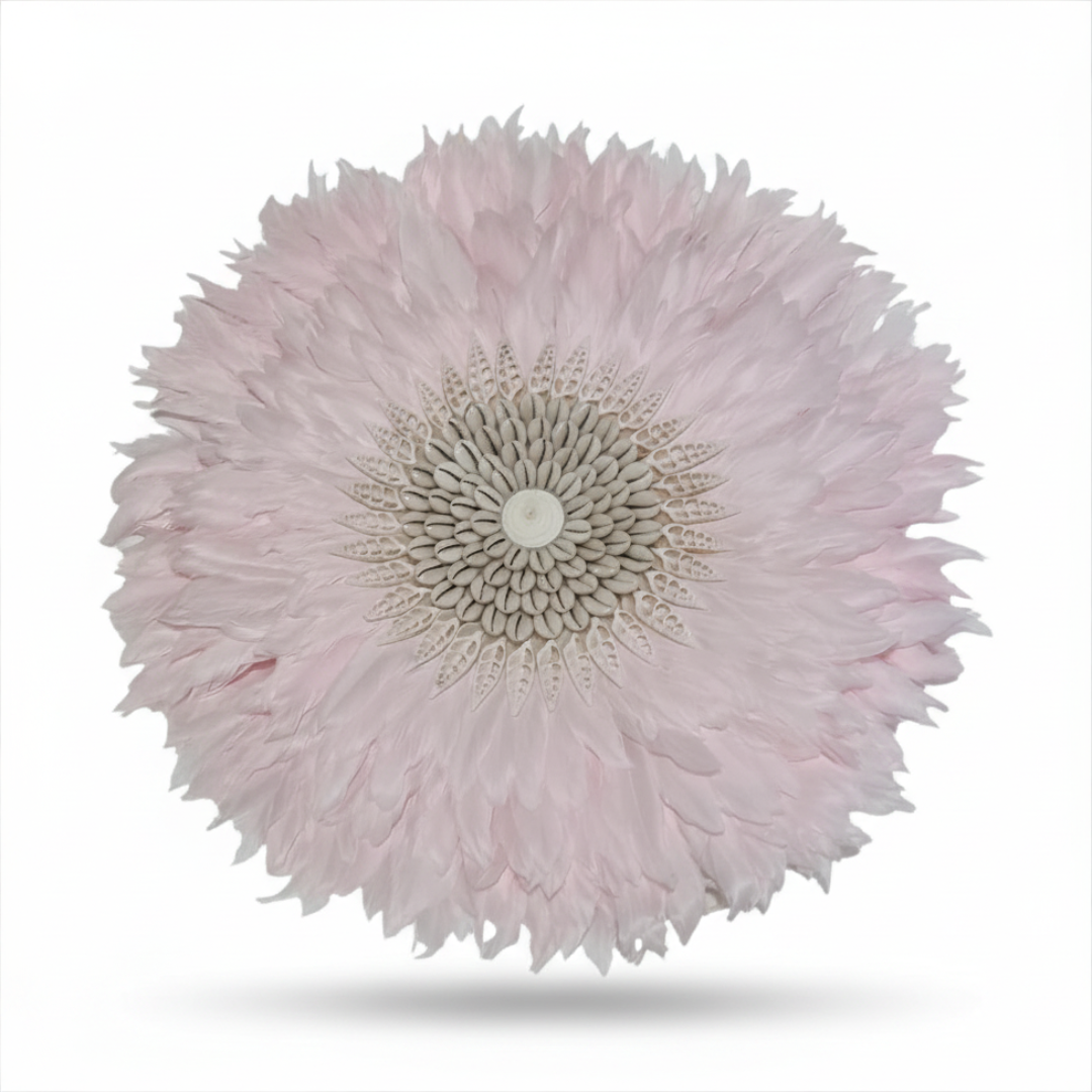 Close-up of a pink feather art with a white center on a white background