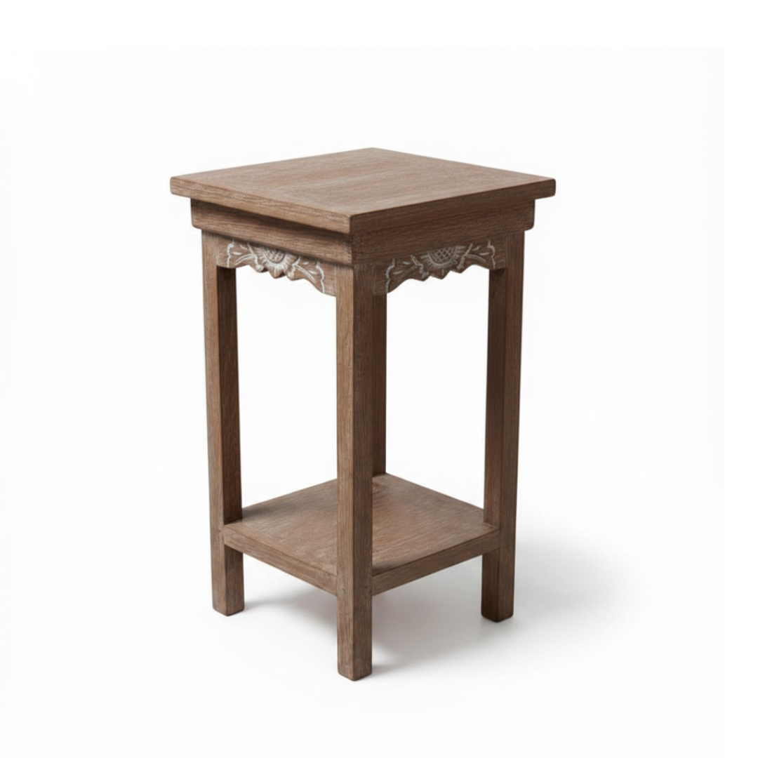 Hand-carved floral apron detail on a Balinese teak side table — white background