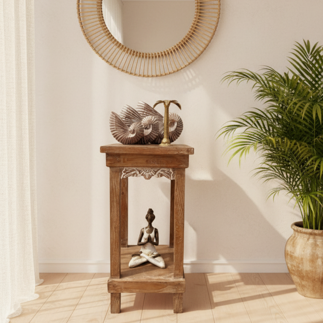 Bright coastal home interior with brown shell sculptures and brass candleholder on top shelf, meditating figure on lower shelf — Azure Decor
