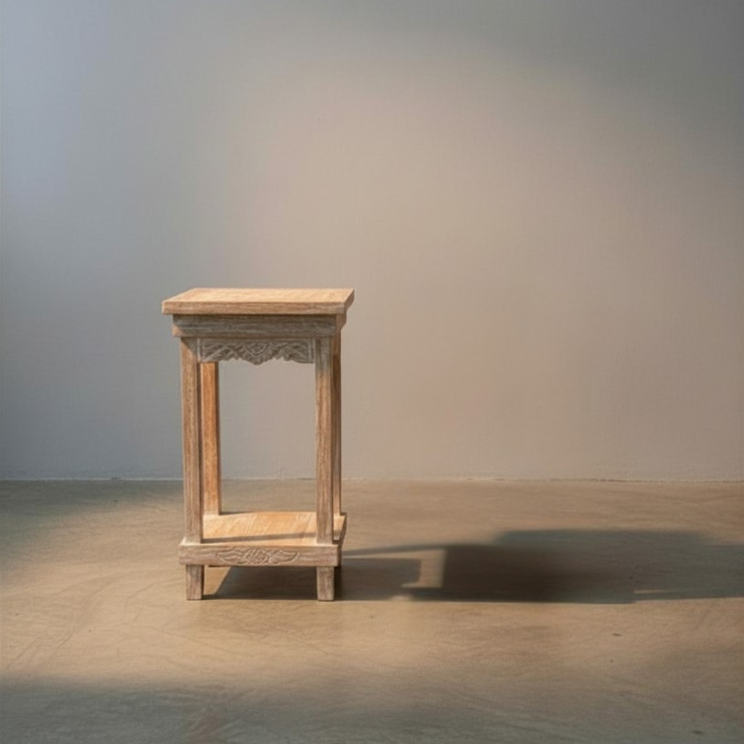 Hand-carved Balinese furniture with intricate detailing on a plain background