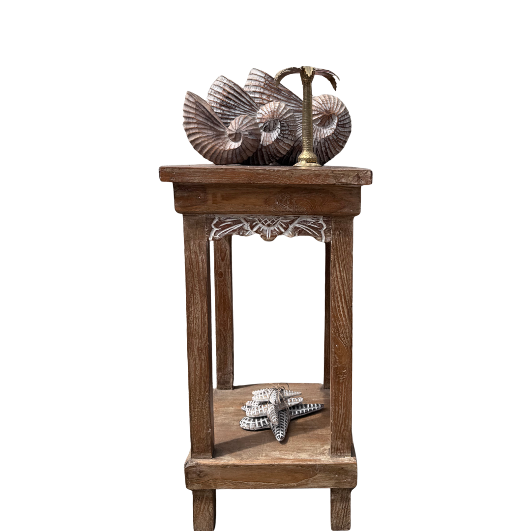 Wooden side table with decorative items on a white background