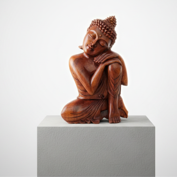 Resting Buddha Solid Wood Carving displayed on a grey plinth, white background