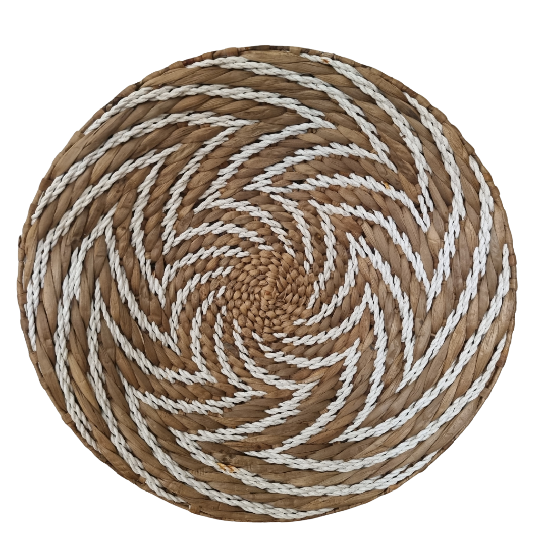 Seagrass spiral wall art hung above bed in Scandi boho bedroom – handwoven natural wall décor Australia
