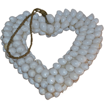 A white heart-shaped wall decor made of shells with jute rope hanging at the top.