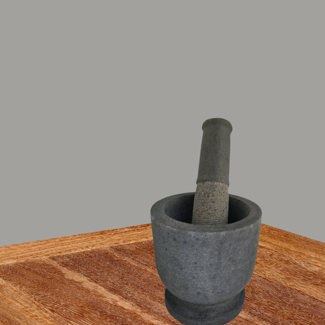 Natural stone mortar and pestle set on a timber kitchen bench, showing textured volcanic stone finish and sturdy base
