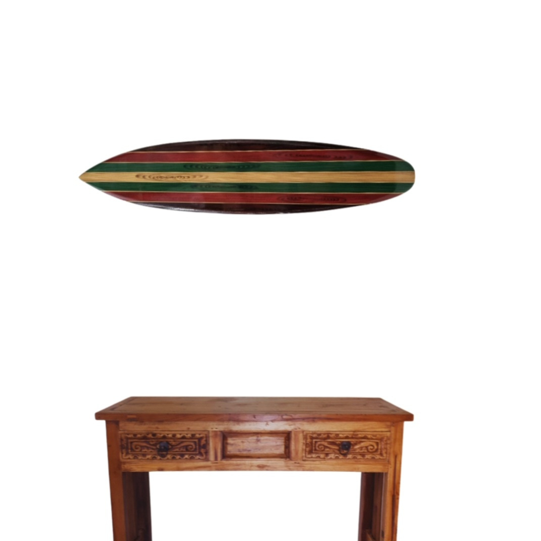 wooden surboard wall art above a hall way table on a white back wall