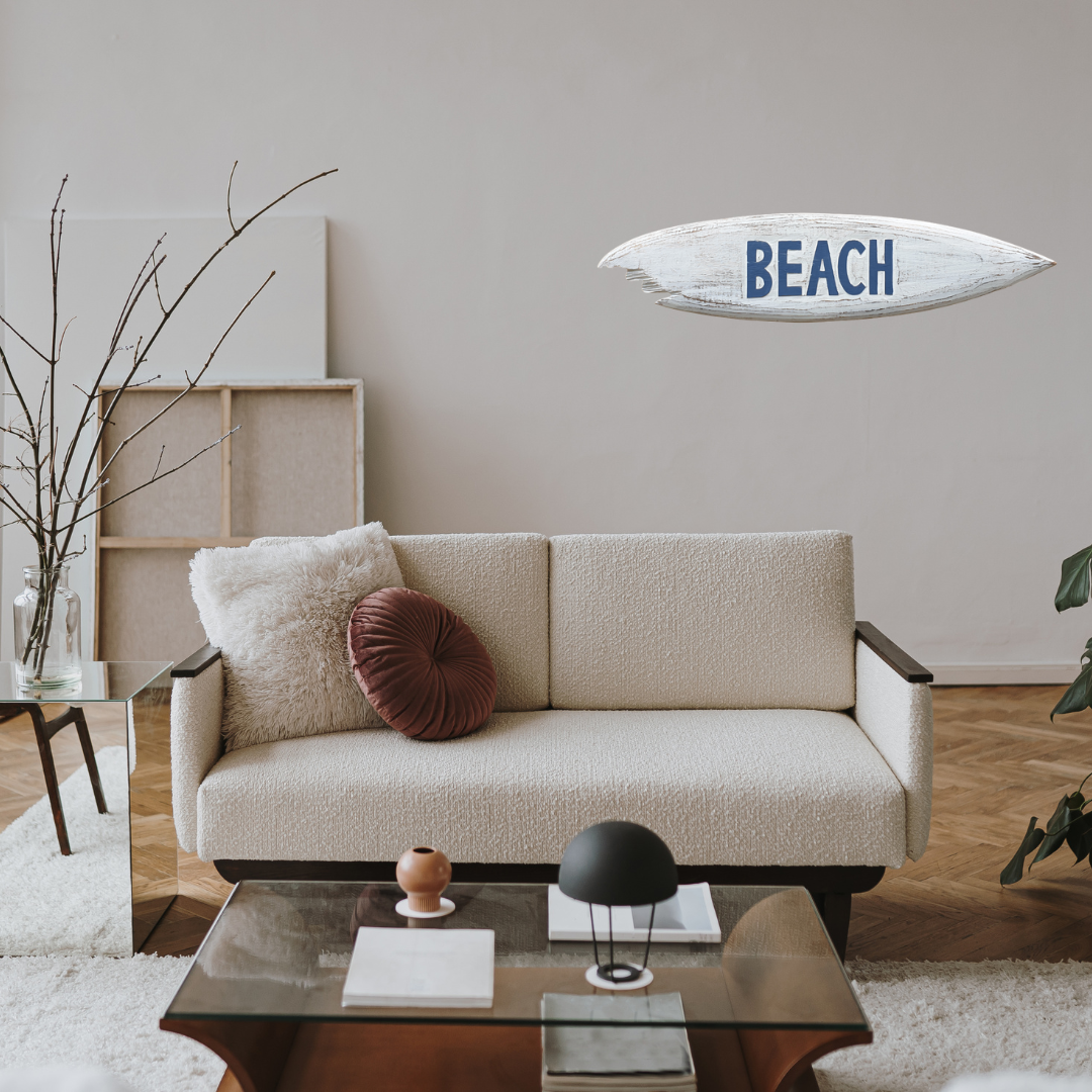 Modern living room with a beige sofa, coffee table, and decorative items.