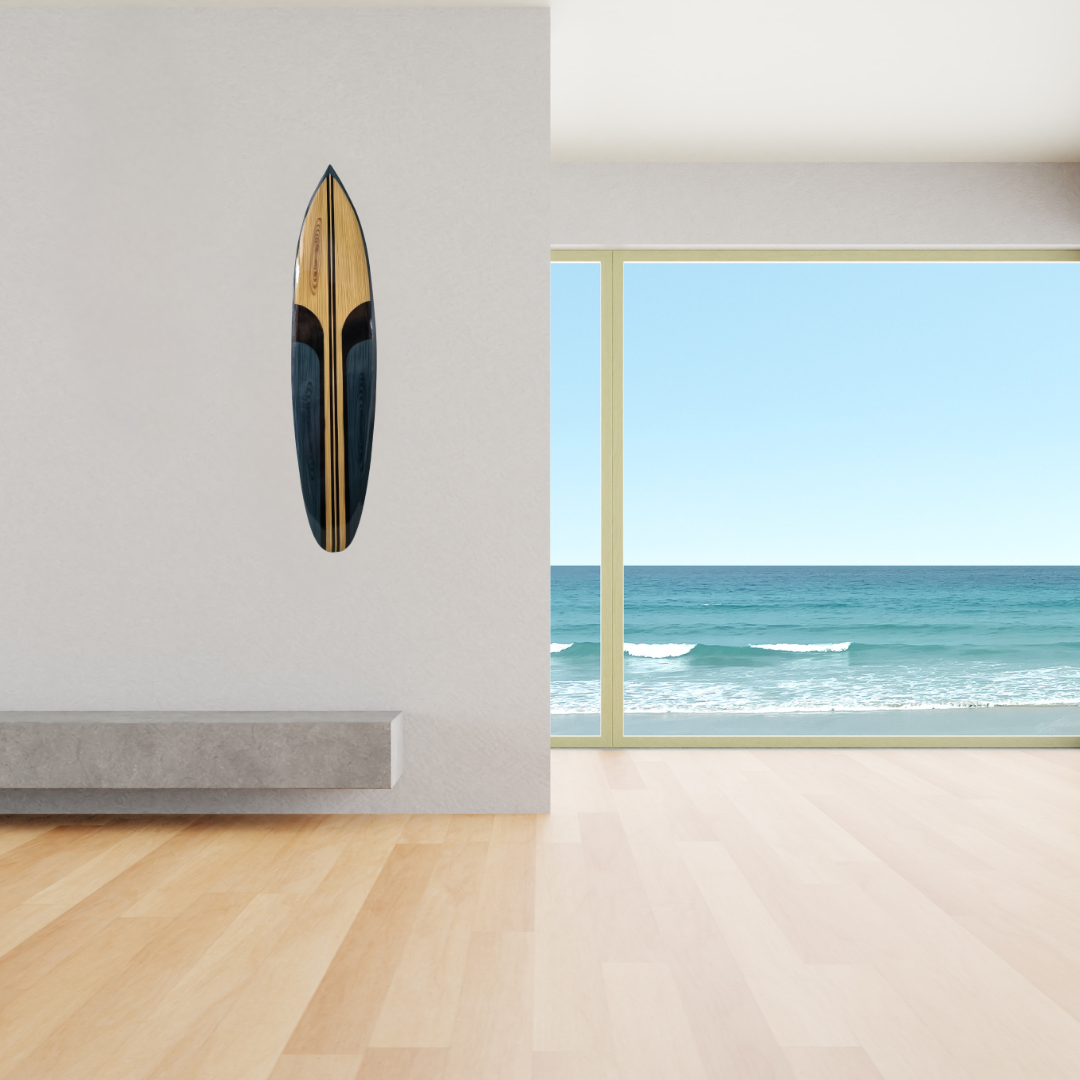 Wooden surfboard on a wall with a view of the ocean through a window.