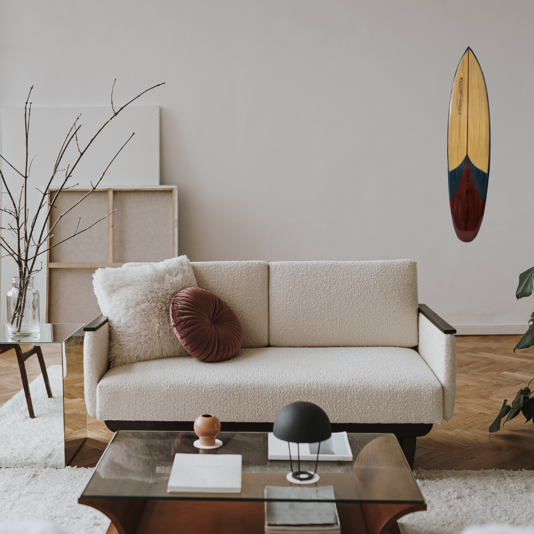 Modern living room with a beige sofa, coffee table, and decorative items.