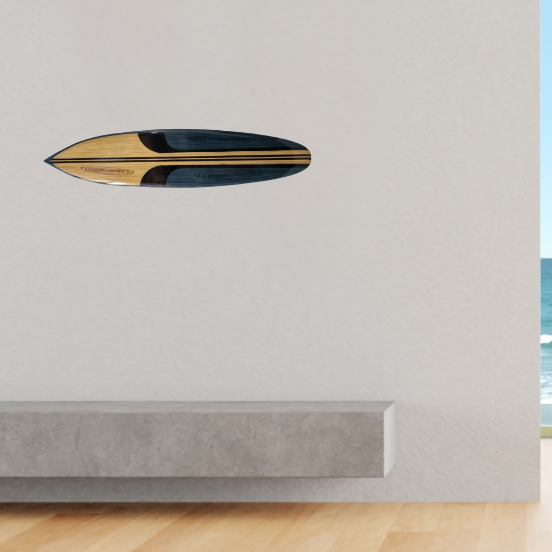 Wooden surfboard on a white wall above a concrete ledge.