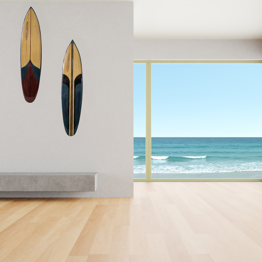 Two surfboards on a wall with a window view of the ocean.