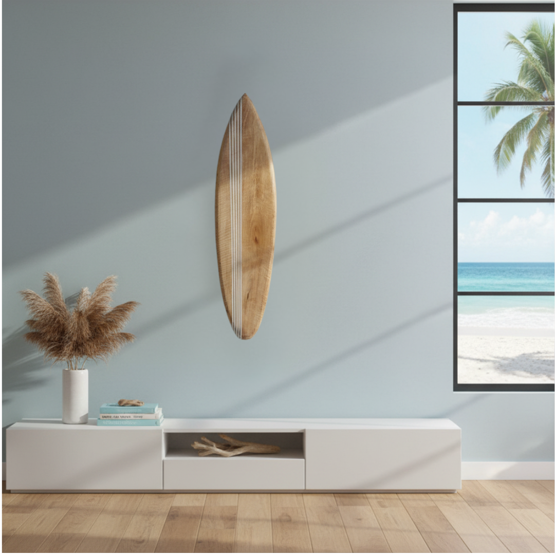 Natural timber board mounted on a blue-grey wall above a white low-profile TV unit, pampas grass in a white vase, beach photography prints on the right