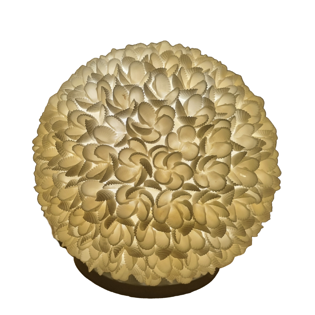 Switched on, warm golden light glowing through layered shell petals