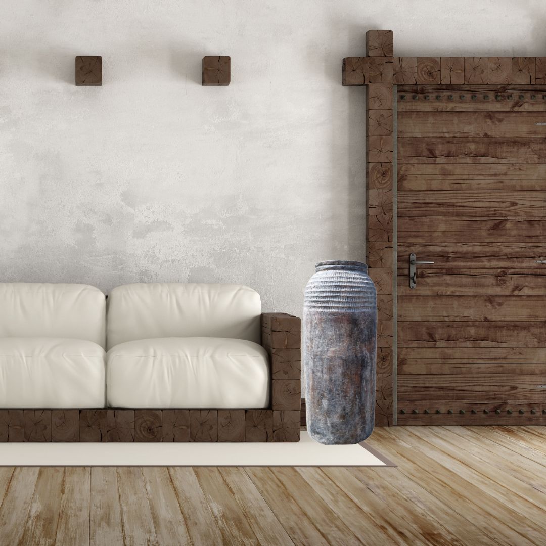 Modern interior with a white sofa, wooden floor, and decorative vase.