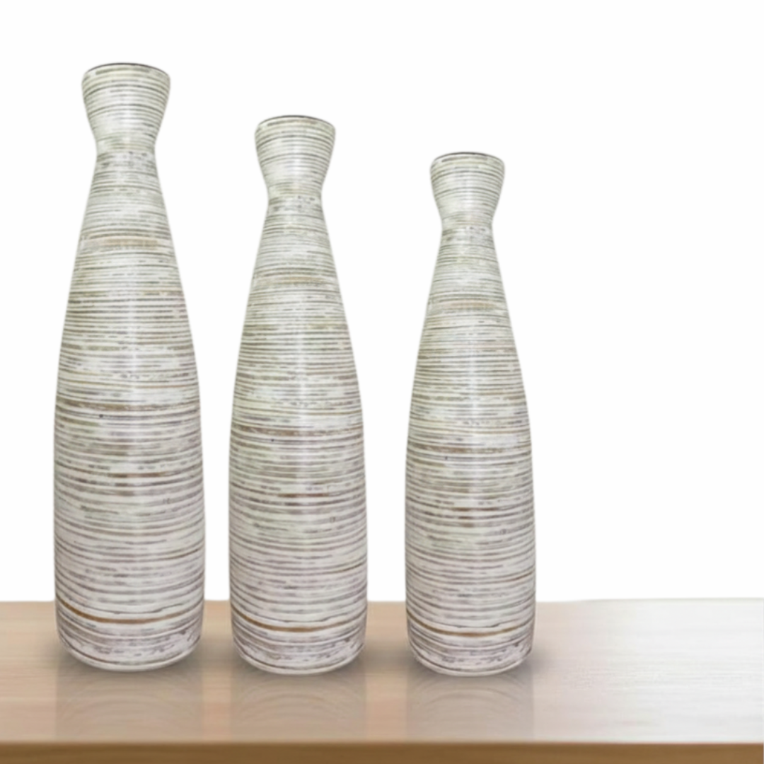 Three textured ceramic vases on a wooden surface with a white background