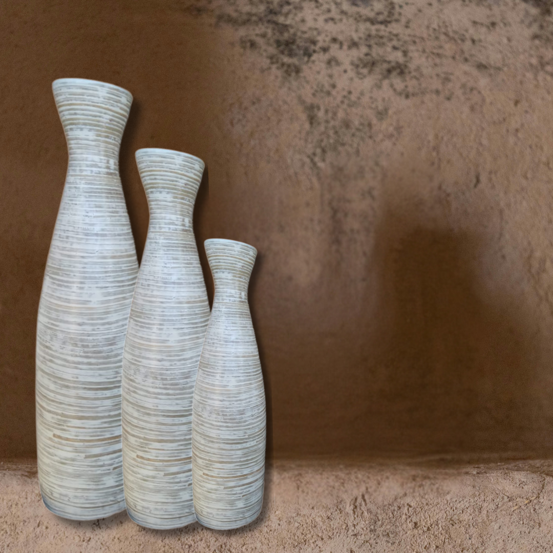 Three textured ceramic vases on a textured brown surface
