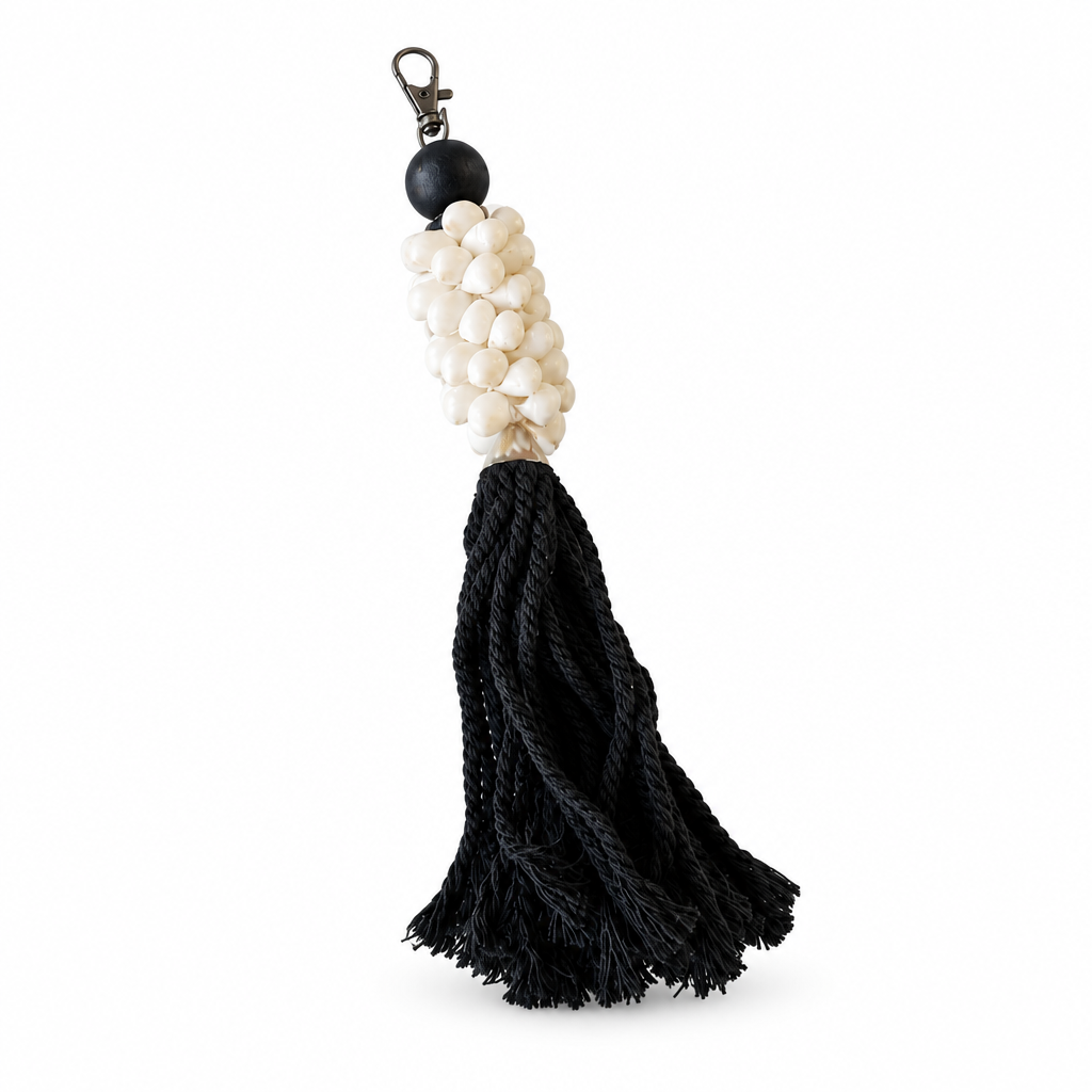 Black on white: Black Tassel and Moon Shell Decor on white, with ivory beads, a black round bead and dark metal clip.
