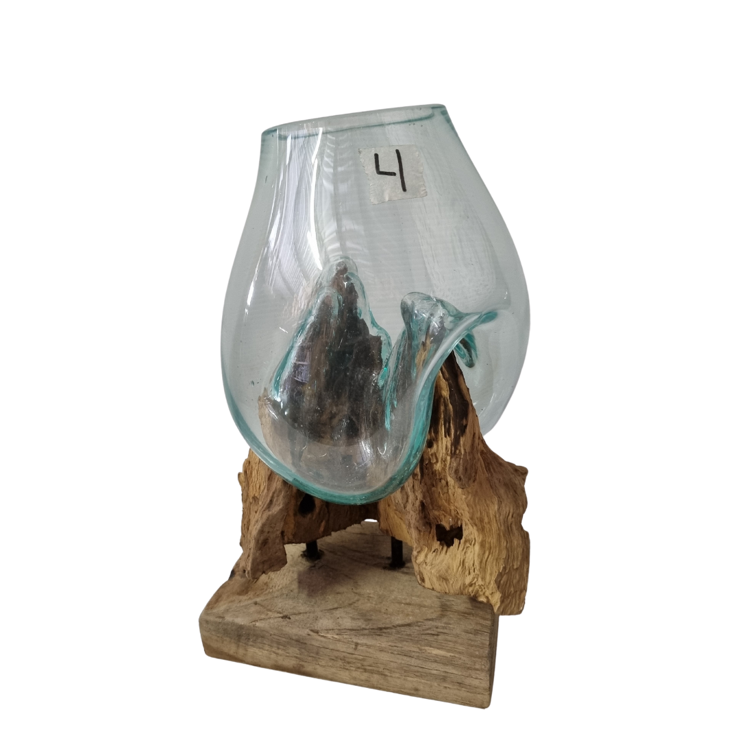 Handblown aqua-tinted glass bowl sitting on a textured driftwood root with flat timber base, white background