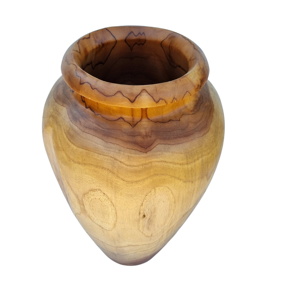 Top-down view of a hand-carved wooden urn vase showing decorative carved rim detail and natural teak wood grain variation from light to dark tones