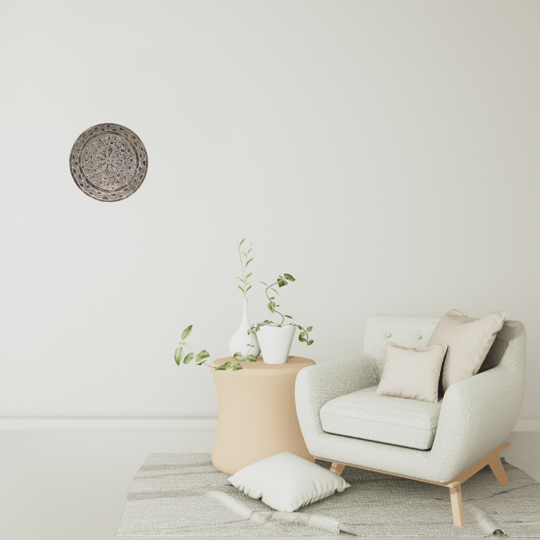 tribal style art on wall with Modern armchair with a side table and decorative items in a minimalistic room.