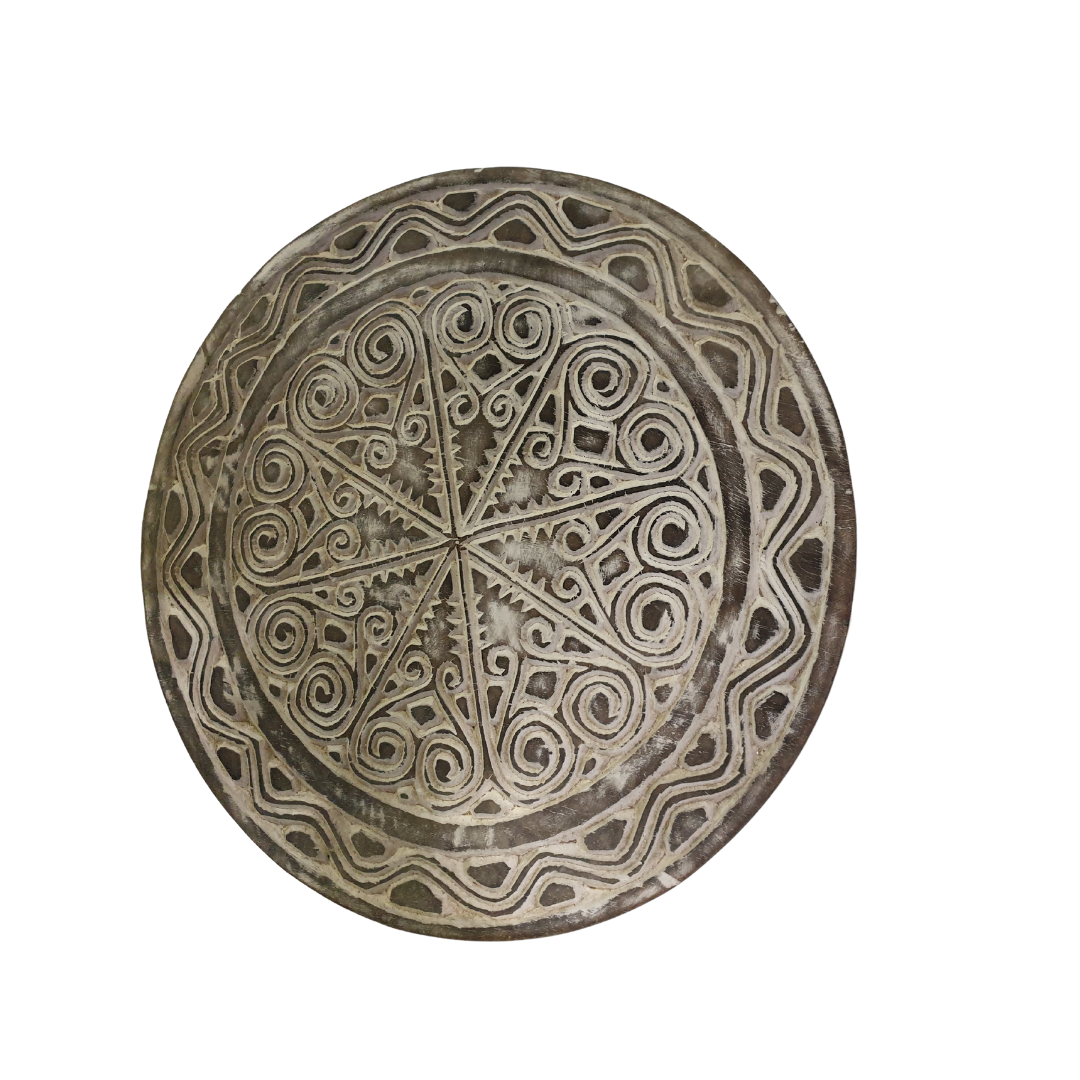 A circular tribal artwork wall hanging made of wood with a rustic design, featuring brown tones and whitewash art scroll finish.