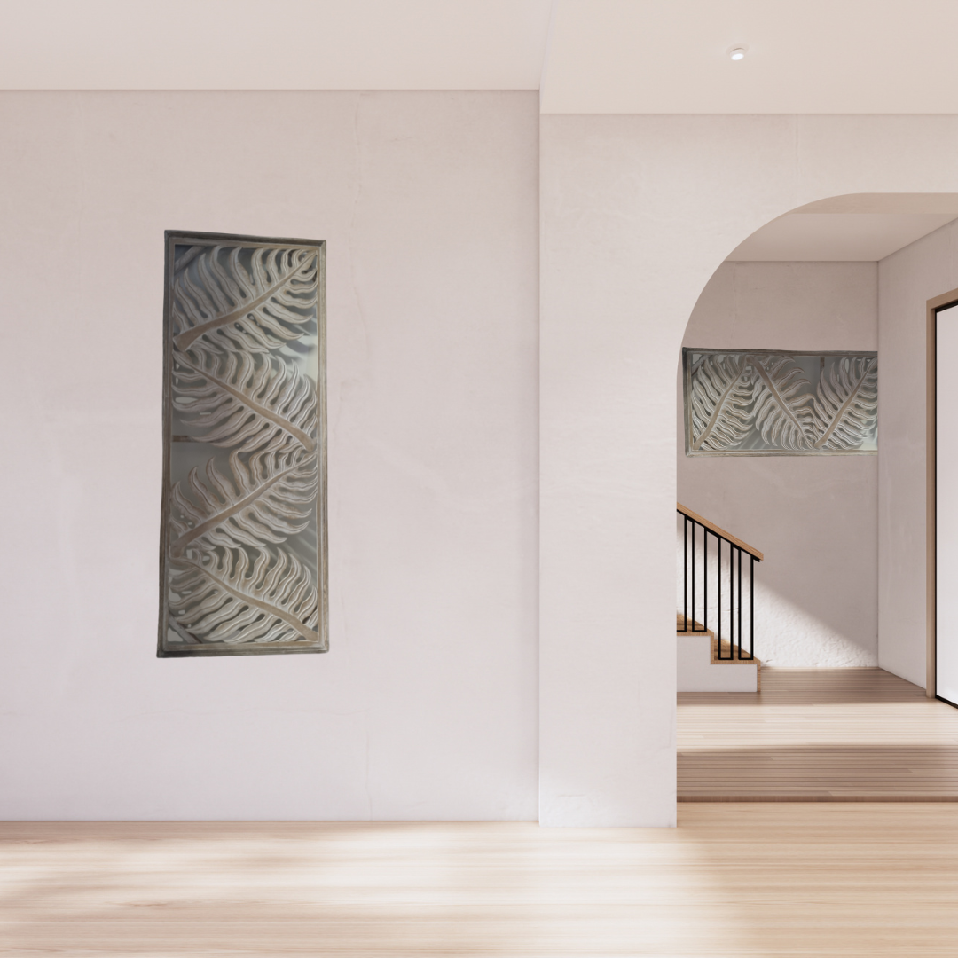 Tropical fern leaf wall hanging in natural wash finish displayed vertically in a modern entryway, with horizontal display visible through archway