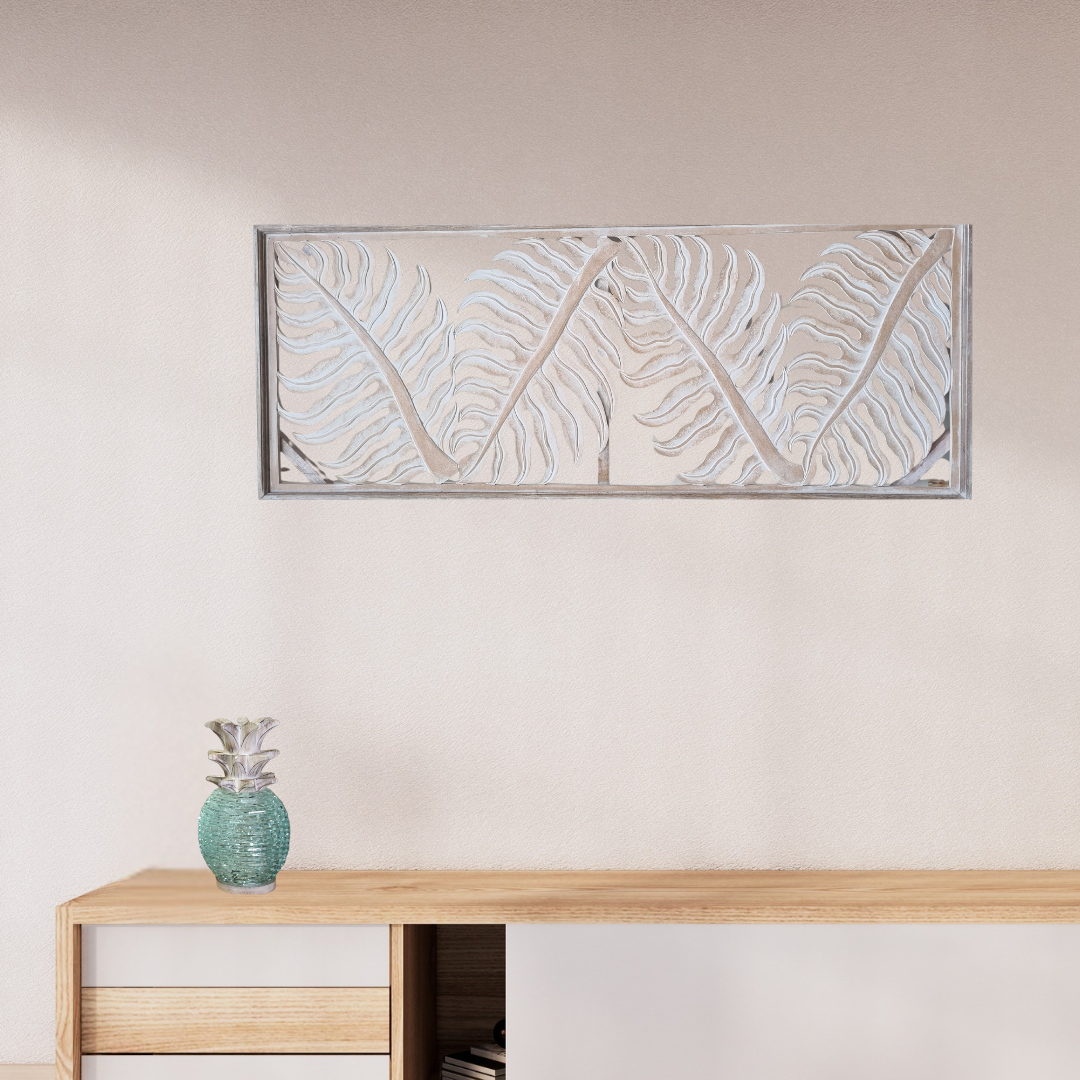 Tropical fern leaf wall hanging in natural wash finish displayed horizontally above a timber console table with pineapple sculpture